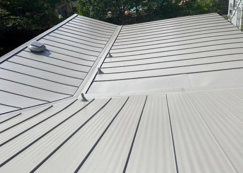 Solar attic fan installed on a metal roof for Roof Ventilation in Big Lake